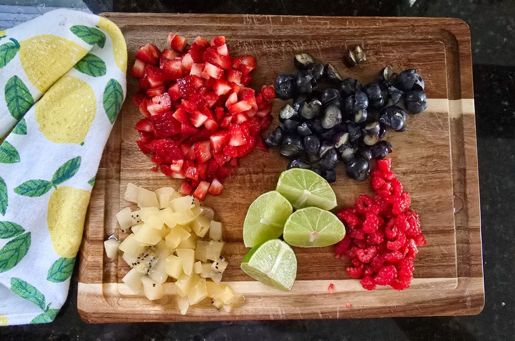 cut up fruit on a wooden cutting board