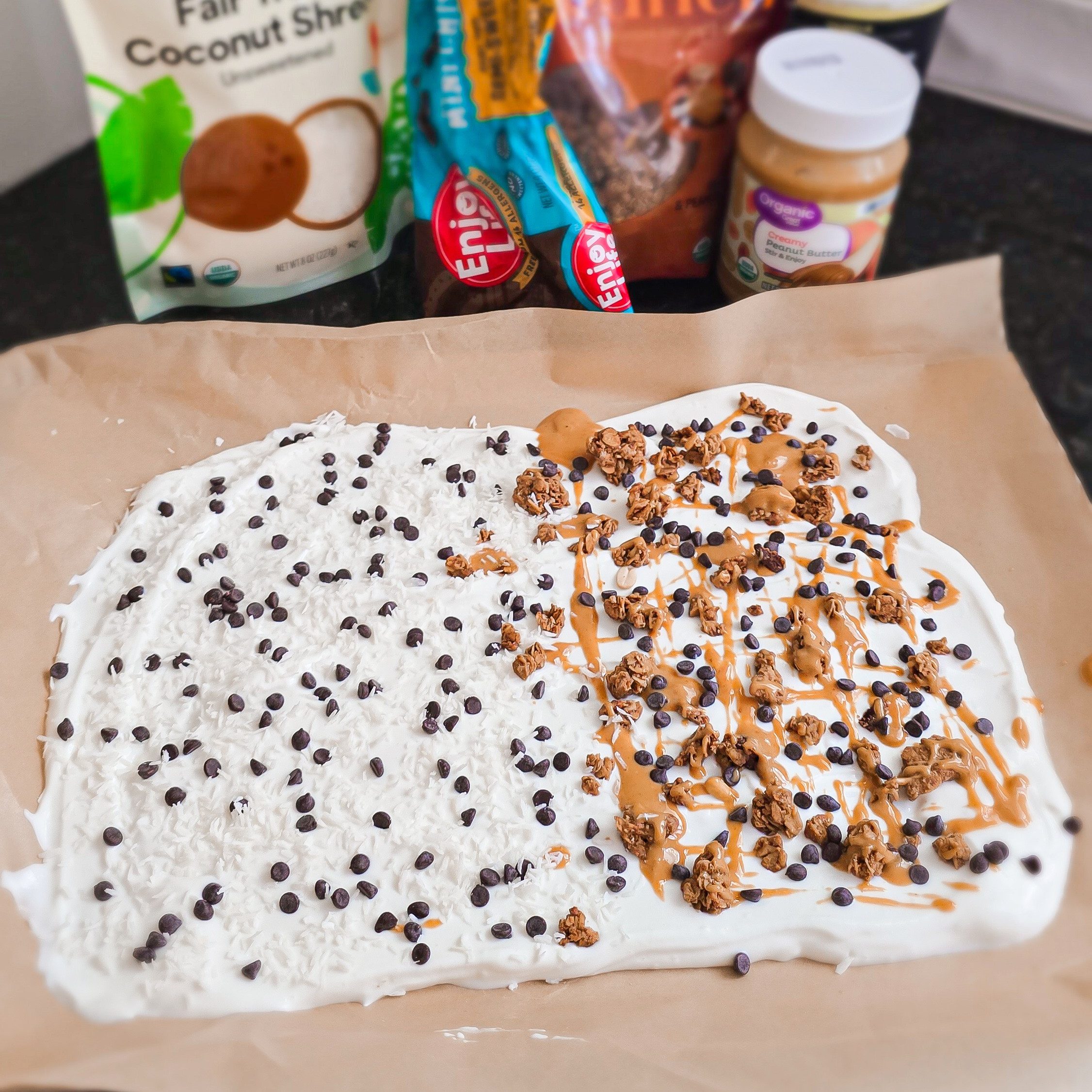 yogurt bark with toppings on parchment paper.